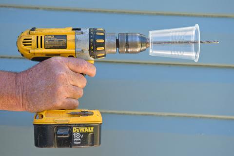 Pre-drill a transparent plastic cup