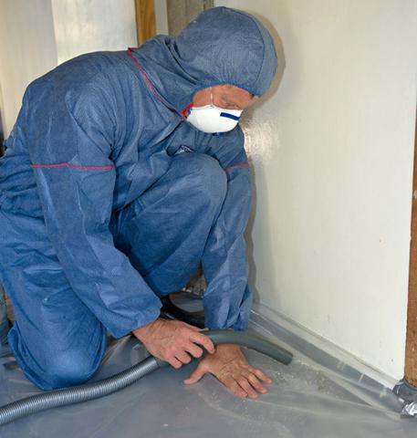 Using an H rated industrial HEPA filter vacuum to remove dust and debris